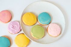 a white plate topped with different colored cookies