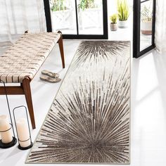 a white and brown rug sitting on top of a floor next to a wooden bench