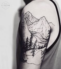 a man with a mountain tattoo on his arm