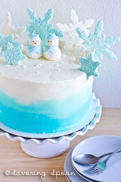 a blue and white cake with snowflakes on top