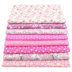 a stack of pink and white fabric on top of each other, with flowers in the middle