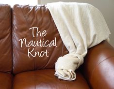 a brown leather couch with a blanket on top of it and the words, the nautical knot