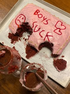 a cake with pink frosting and red writing on it