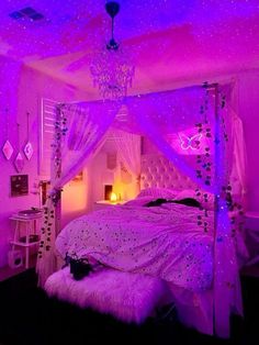 a bedroom with purple lighting and white bedding