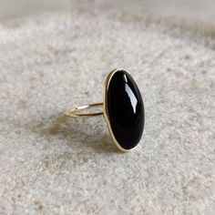 ITEM DESCRIPTION: >>The ring is made from Solid 14K Yellow Gold. >>Gemstone used is absolutely natural and ethically sourced. >>Natural Black Onyx in Oblong Oval Shape in bezel setting is studded on it with utmost precision. Gem: Black Onyx Gem size & shape: 20×10 mm and Oblong Oval Gem weight: 8.44 Carats Gold purity: 14K (58.33% approx.) Gold weight: 1.14 grams Gross weight of ring: 2.83 grams The Gold purity is guaranteed and it comes with authentic 14K gold hallmark. Since these Rings are ha Fine Jewelry Onyx Oval Ring, Fine Jewelry Oval Onyx Ring, Black Cabochon Ring In 14k Gold, Black Cabochon 14k Gold Rings, Black 14k Gold Cabochon Ring, 14k Gold Black Cabochon Rings, Oval Onyx Fine Jewelry, Black Oval Jewelry With Bezel Setting, 14k Gold Black Ring With Bezel Setting