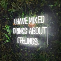 a neon sign that says i have mixed drinks about feelings on the side of a wall