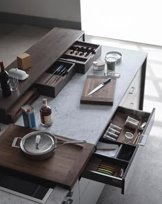 a kitchen table with utensils, knives and other items on it's trays