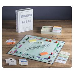 the monopoly board game sits on a table next to its contents