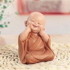 a small buddha statue sitting on top of a table