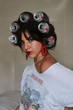 a woman with lots of soda cans in her hair