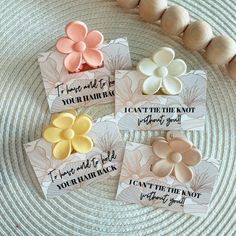 four flower magnets are sitting on a plate