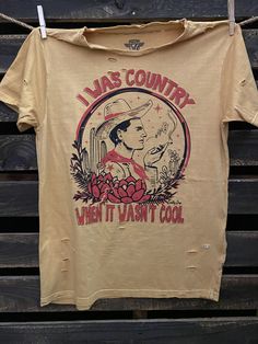 I Was Country When it wasn't Cool unisex distressed T shirt in vintage wash white and Mustard Vintage country western cowboy T shirt 40 Singles Jersey 100% Cotton Premium quality ringspun and compacted cotton Fine Cotton Jersey that is pigment dyed for a more vintage look Features tears and destroyed features at neck and on body Each piece is unique as this process is done by hand! 3.8 oz Made In USA Every garment dye item can be a slightly different shade in color since this is a laundry dye pr Distressed T Shirt, Cool Countries, Country Western, Vintage Country, Western Cowboy, Large White, Vintage Tshirts, Vintage Look, Vintage Looks