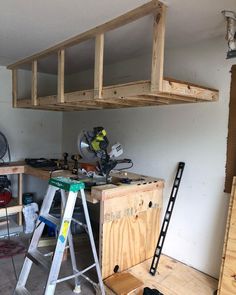 the workbench is being worked on in the garage with tools and wood planks