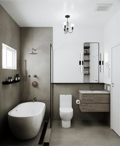 a white toilet sitting next to a bath tub under a bathroom mirror above a sink