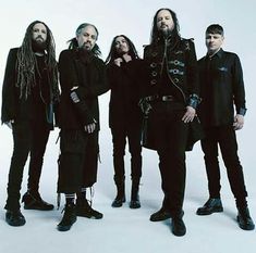 five men with dreadlocks standing in front of a white background