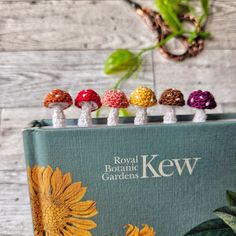 the royal botanical garden book is lined up with small mushrooms on it's cover