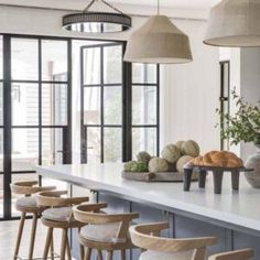 a kitchen filled with lots of counter top space and wooden stools next to it