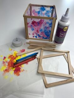 the supplies needed to make an art project include paint, glue and wooden frames with colored crayons