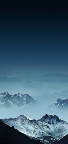 the mountains are covered in snow and clouds at night, as seen from an airplane