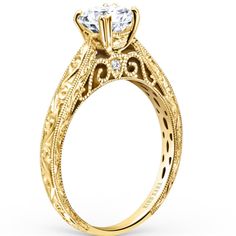 a yellow gold engagement ring with an intricate design