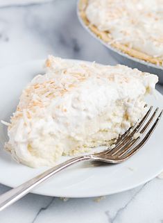 a piece of coconut cream pie on a plate with a fork