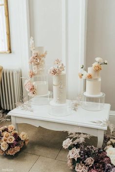 wedding cakes and flowers on a white table