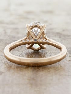 an engagement ring with a diamond in the center on top of a wooden table,