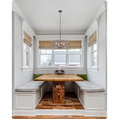 a kitchen with a table, bench and window seat in it's center area