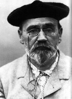 an old black and white photo of a man wearing a hat