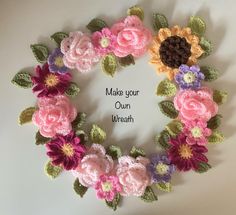 a crocheted wreath with flowers and leaves on the side that says make your own wreath