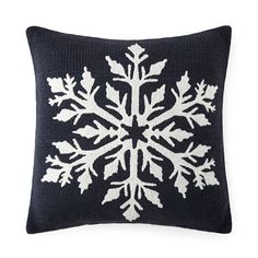 a knitted snowflake pillow on a white background