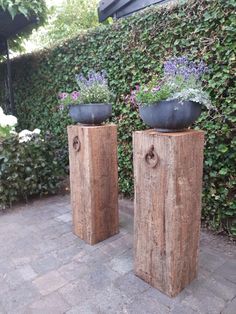 two wooden planters sitting next to each other