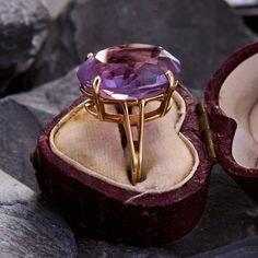 This classic cocktail ring is centered with an elegant oval cut amethyst. The chunky gem is held aloft by a split shoulders setting with a light patina. The ring is crafted in 14k yellow gold is currently a size 5.25. Cocktail Ring Designs, Amethyst Cocktail Ring, Classic Cocktail, Amethyst Cluster, Classic Cocktails, Amethyst Ring, Cluster Ring, Cocktail Ring, Cocktail Rings