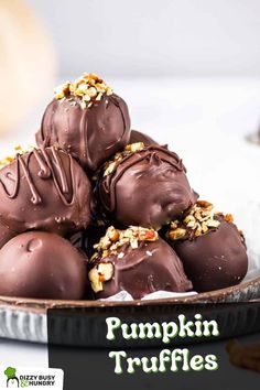 chocolate covered pumpkin truffles stacked on top of each other in a pie pan