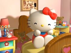 a hello kitty sitting on top of a bed in a bedroom