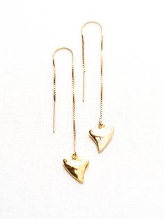 "Gold Earrings | Gold Ear Thread Earrings | Ear Threader Earrings | Shark Tooth Earrings | Gold Shark Tooth Earrings | Gold Dangle Earrings | Gold Threader Earrings | Gold Minimal Earrings Mano - (mah NO) - shark. Gorgeous gold threader earrings. These gold dangle earrings feature stunning gold shark teeth charms. Minimal, edgy statement earrings reserved for only the truly chic. Handmade on Maui, Hawaii. ✦ DETAILS ✦ ✧ 2.25\" Length. ✧ 14kt gold filled. ✧ Gold Vermeil Shark Teeth (gold plated st Adjustable Pierced Heart Drop Earrings, Adjustable Heart Shaped Drop Earrings, Brass Earrings With Adjustable Chain For Gift, Adjustable Dangle Heart Earrings, Gift Long Drop Linear Earrings With Ear Wire, Anniversary Dangle Threader Earrings, Shark Tooth Earrings, Gold Threader Earrings, Tooth Earrings