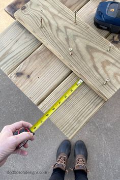 someone is measuring the length of a piece of wood