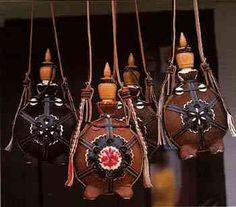 four brown purses hanging from hooks in front of a door with decorations on them