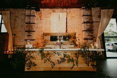 the interior of a church decorated with greenery and candles for an outdoor wedding ceremony