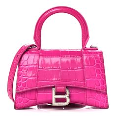 This is an authentic BALENCIAGA Shiny Calfskin Crocodile Embossed Hourglass Top Handle Bag XS in Lipstick Pink. This stylish and structured handbag is crafted of crocodile embossed in pink calfskin leather. The bag features a sturdy leather top handle with ruthenium links and a prominent B logo on the front flap, and an optional, adjustable shoulder strap. The front flap opens with a magnetic snap closure to a smooth pink leather compact interior. Balenciaga Hourglass Bag, Hot Pink Bag, B Logo, Womens Designer Bags, Luxury Purses, Best Handbags, Balenciaga Bag, Cute Bags, Large Tote Bag