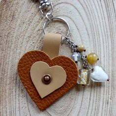 a heart shaped keychain with charms attached to it