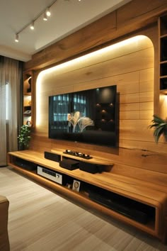 a living room with wood paneling and built - in entertainment center on the wall