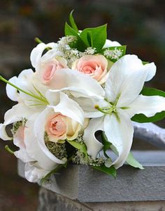 a bouquet of flowers sitting on top of a cement block