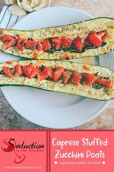 two stuffed zucchini boats on a white plate with a pink flower in the background