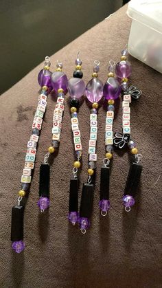 some purple and black beads are on a table