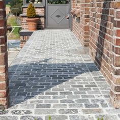 an entrance to a brick building with a gray door