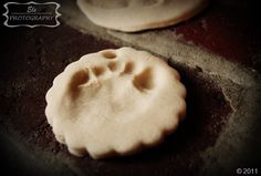 two cookies that have been made to look like dogs paw prints are on the cookie sheet