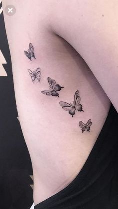 a woman's thigh with three butterflies on her left side, and the bottom half of