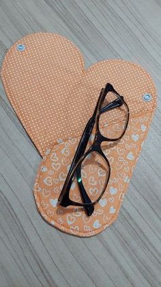 a pair of glasses sitting on top of an oven mitt