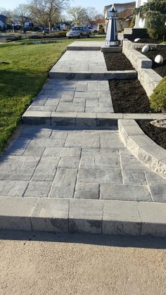 the walkway is lined with stone blocks and grass